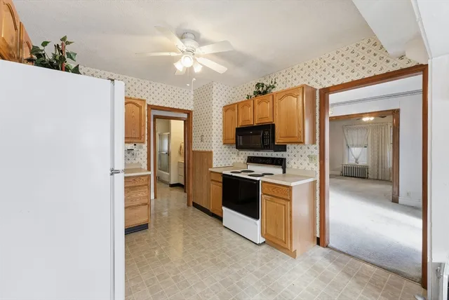 a kitchen with stainless steel appliances a stove top oven a sink and dishwasher