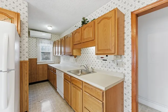 a kitchen with a sink stove and refrigerator