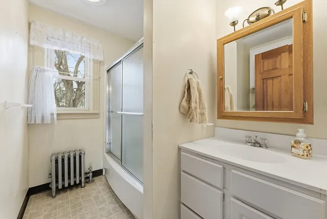 a bathroom with a sink a mirror and a shower