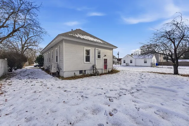 a view of a house with a yard covered in snow