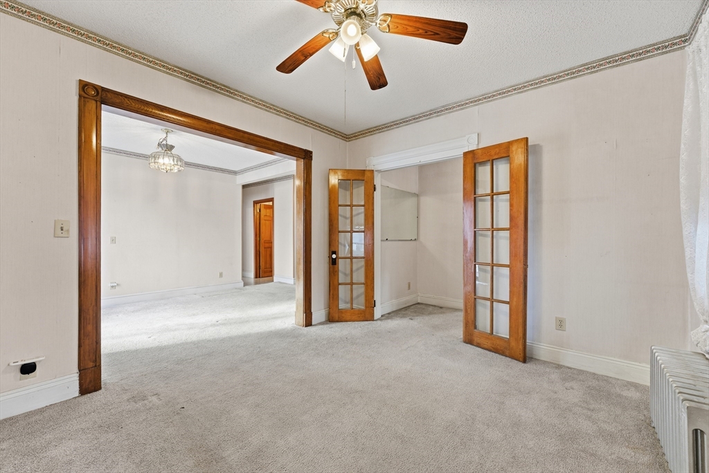 60 Barrison Street Springfield, MA 01109 - Photo 6 of 25 an empty room with chandelier fan and windows