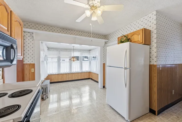a kitchen with a refrigerator and a sink
