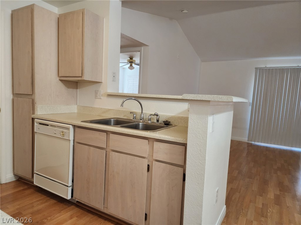231 West Horizon Ridge Parkway, Unit 1127 Henderson, NV 89012 - Photo 18 of 39 A functional kitchen provides ample counter space, a double sink, and a dishwasher, perfect for daily routines.