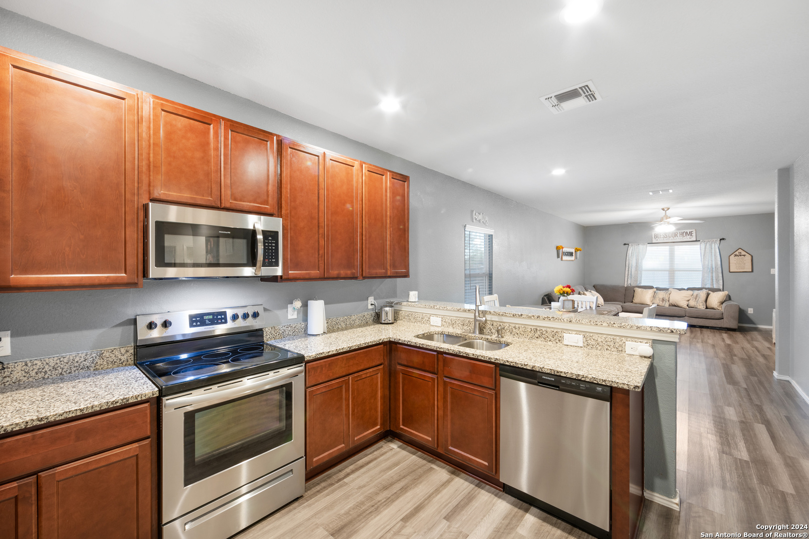 7104 Quarter Moon Converse, TX 78109 - Photo 11 of 28 a kitchen with stainless steel appliances granite countertop a sink stove and microwave