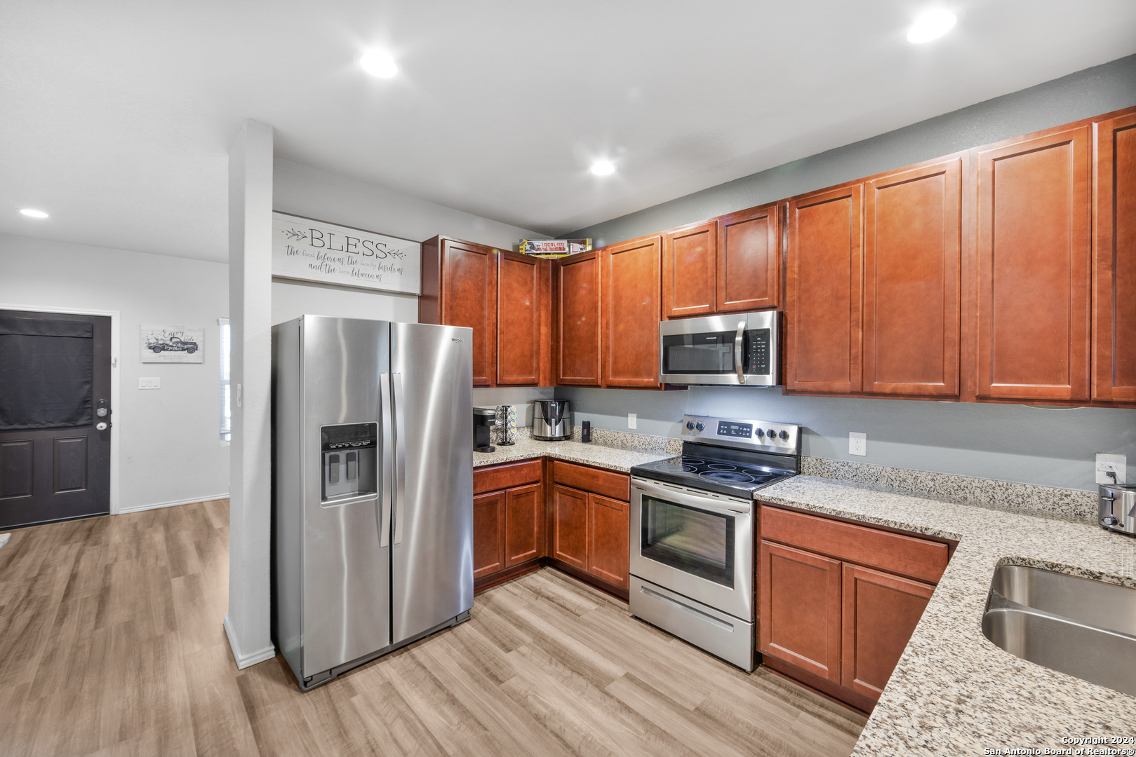 7104 Quarter Moon Converse, TX 78109 - Photo 13 of 28 a kitchen with stainless steel appliances granite countertop a refrigerator stove top oven and sink