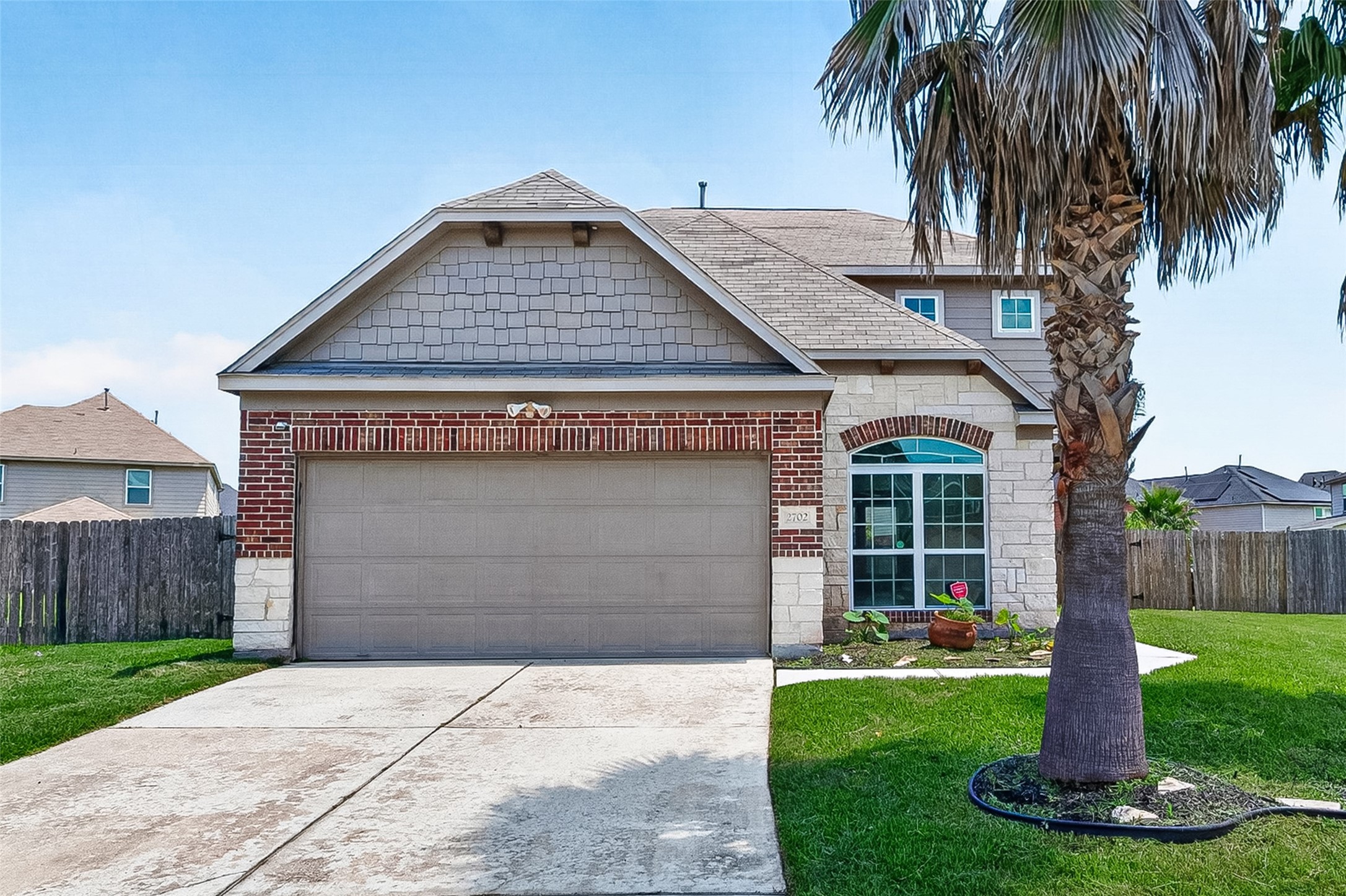 2702 Modano Court Fresno, TX 77545 - Photo 1 of 46 a front view of a house with a yard and garage