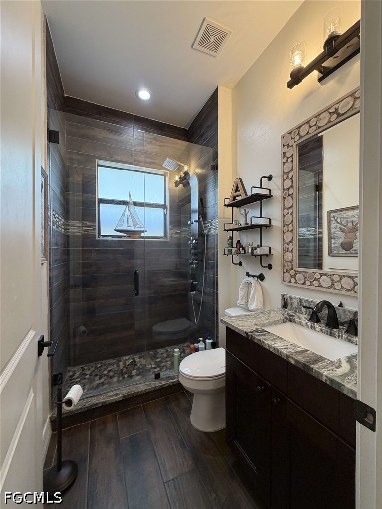 190 2nd Street Southeast Naples, FL 34117 - Photo 15 of 47 a bathroom with a double vanity sink toilet mirror and shower