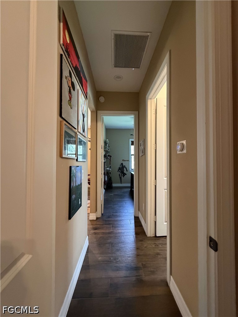 190 2nd Street Southeast Naples, FL 34117 - Photo 18 of 47 a view of a hallway with wooden floor and a living room