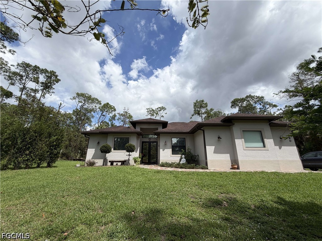 190 2nd Street Southeast Naples, FL 34117 - Photo 2 of 47 a front view of a house with garden