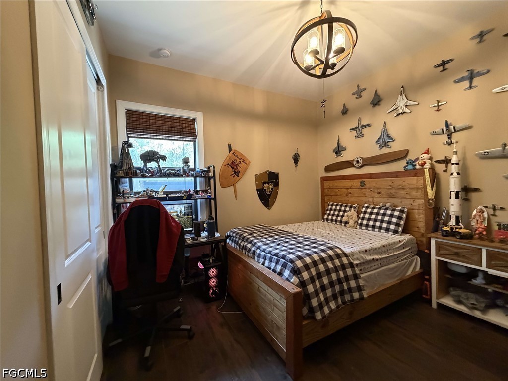 190 2nd Street Southeast Naples, FL 34117 - Photo 22 of 47 a bedroom with a bed a clock on dresser and a table