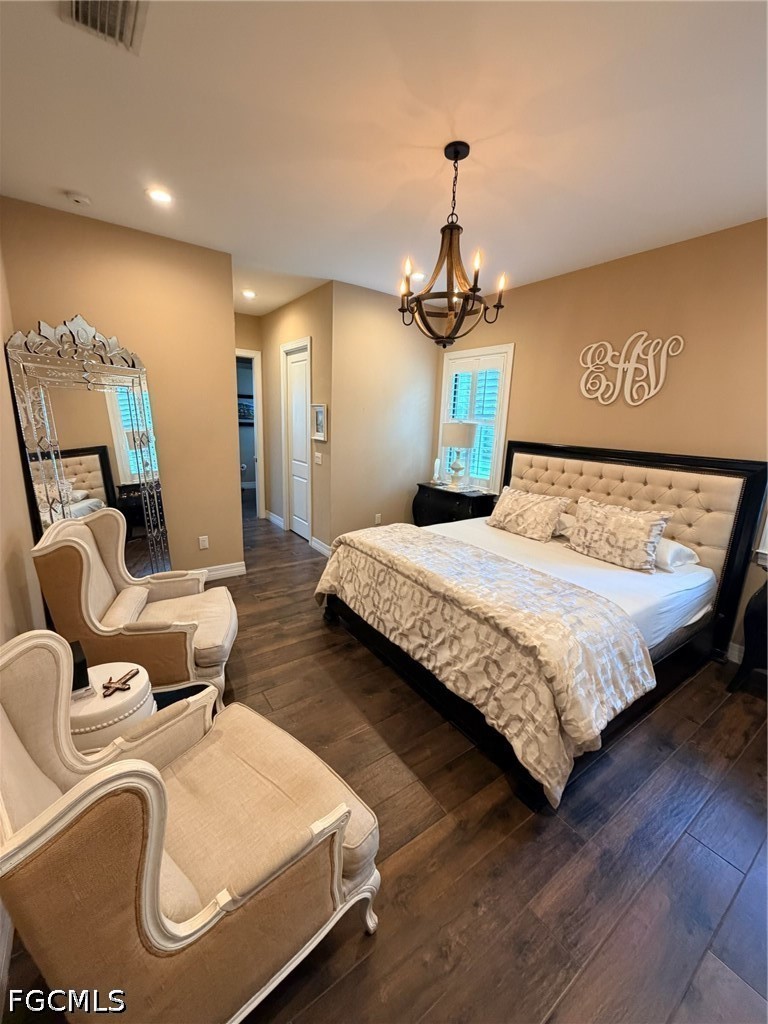 190 2nd Street Southeast Naples, FL 34117 - Photo 24 of 47 a bedroom with a bed and dresser with wooden floor