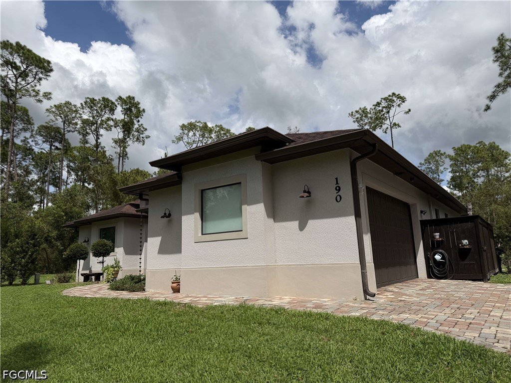 190 2nd Street Southeast Naples, FL 34117 - Photo 3 of 47 a house view with a garden space