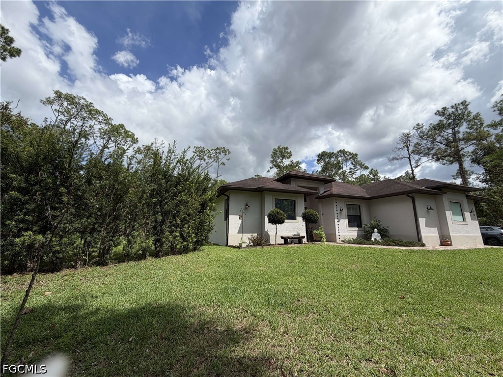 190 2nd Street Southeast Naples, FL 34117 - Photo 4 of 47 a view of a house with yard and porch