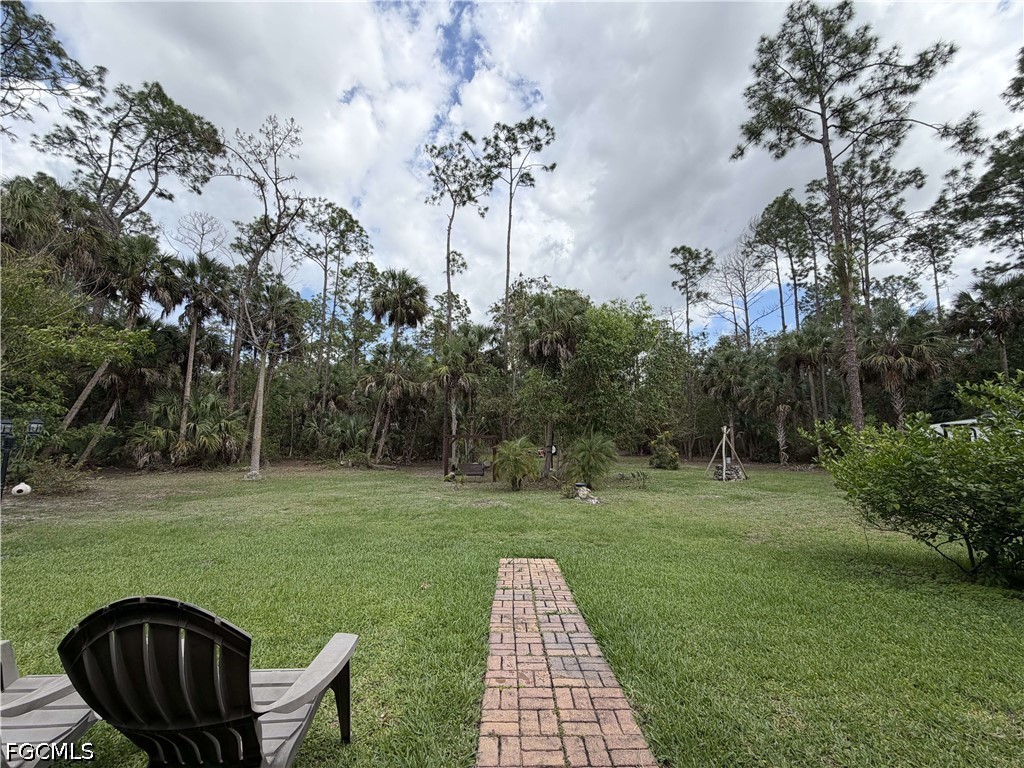 190 2nd Street Southeast Naples, FL 34117 - Photo 42 of 47 a view of a wooden deck and a yard