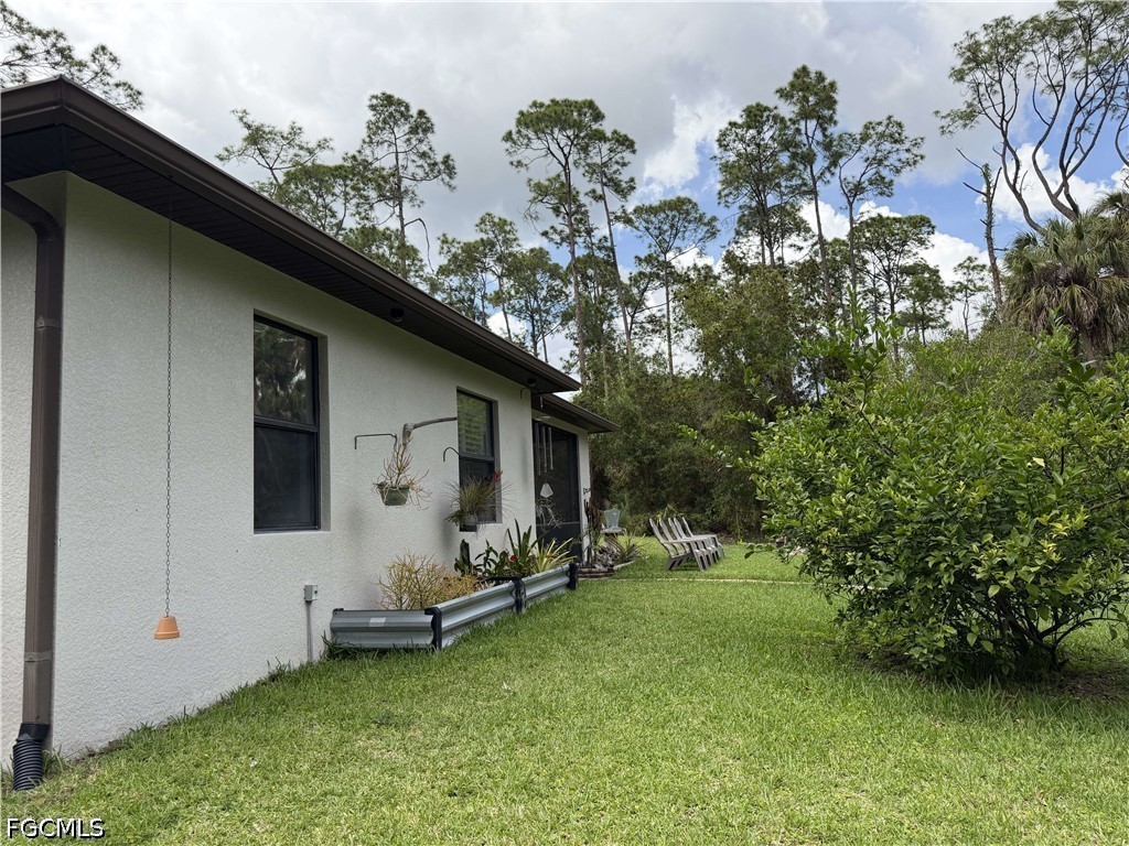 190 2nd Street Southeast Naples, FL 34117 - Photo 45 of 47 a backyard of a house with table and chairs