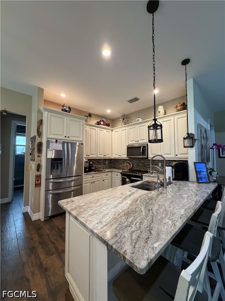 190 2nd Street Southeast Naples, FL 34117 - Photo 9 of 47 a kitchen with stainless steel appliances granite countertop a sink refrigerator and microwave