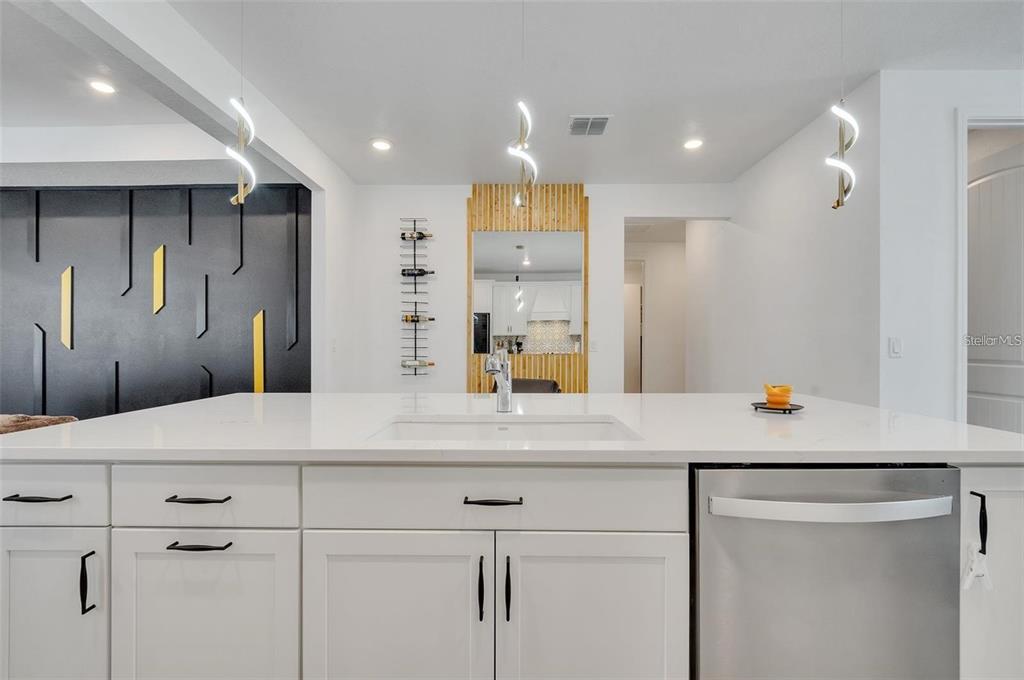 6494 Rover Way St. Cloud, FL 34771 - Photo 14 of 50 a room with kitchen island a counter top space cabinets and stainless steel appliances