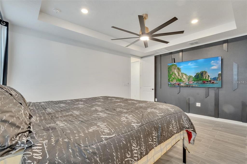 6494 Rover Way St. Cloud, FL 34771 - Photo 18 of 50 a bedroom with a bed and a flat screen tv