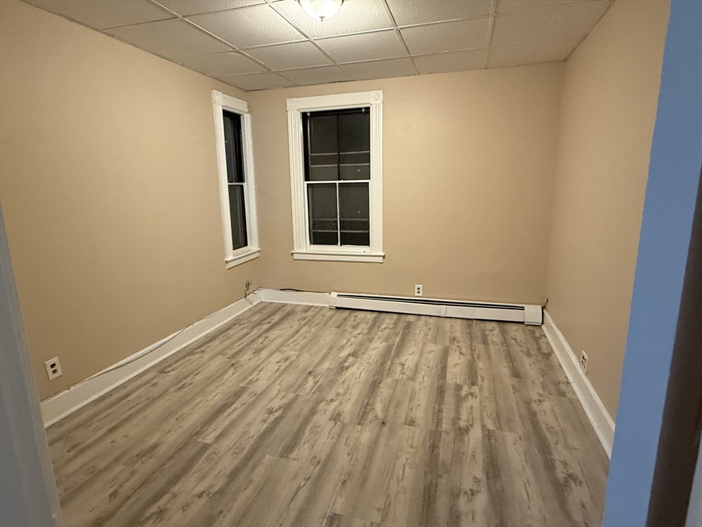 9 Winslow Street, Unit 2 Worcester, MA 01609 - Photo 7 of 10 a view of an empty room with wooden floor and a window
