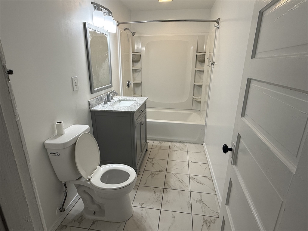 9 Winslow Street, Unit 2 Worcester, MA 01609 - Photo 9 of 10 a bathroom with a toilet sink and shower