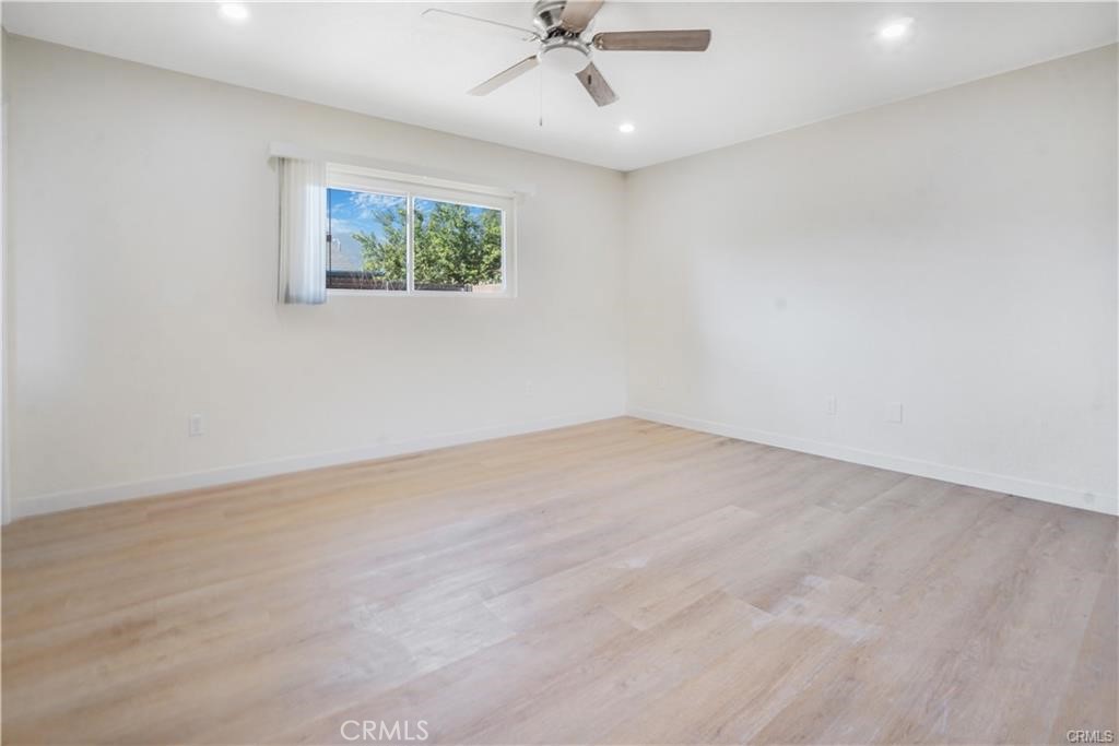 1594 Morgan Road San Bernardino, CA 92407 - Photo 12 of 31 an empty room with a ceiling fan and window