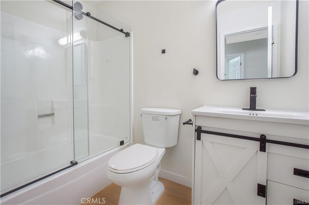 1594 Morgan Road San Bernardino, CA 92407 - Photo 13 of 31 a bathroom with a toilet sink and shower