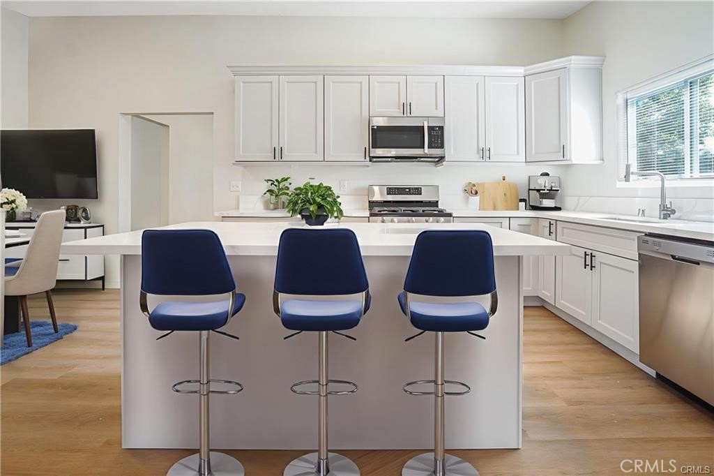 1594 Morgan Road San Bernardino, CA 92407 - Photo 14 of 31 a kitchen with stainless steel appliances granite countertop a stove top oven a sink a dining table and chairs