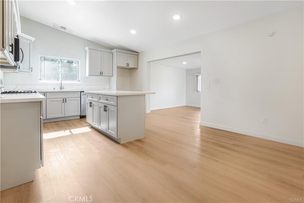 1594 Morgan Road San Bernardino, CA 92407 - Photo 17 of 31 a large white kitchen with a sink and dishwasher with a large window