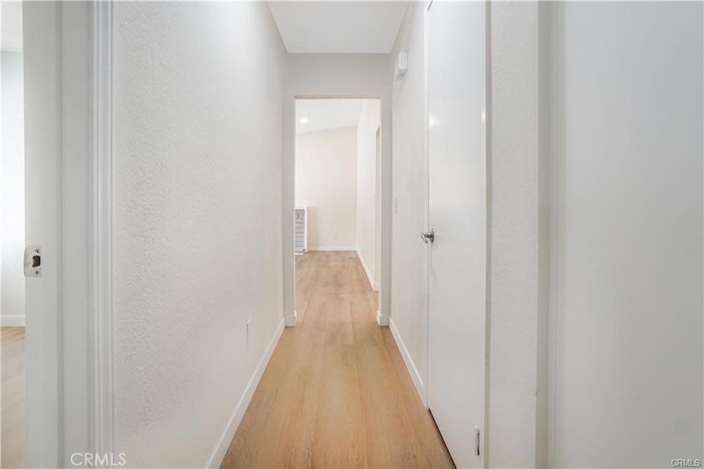 1594 Morgan Road San Bernardino, CA 92407 - Photo 20 of 31 a view of a hallway with wooden floor