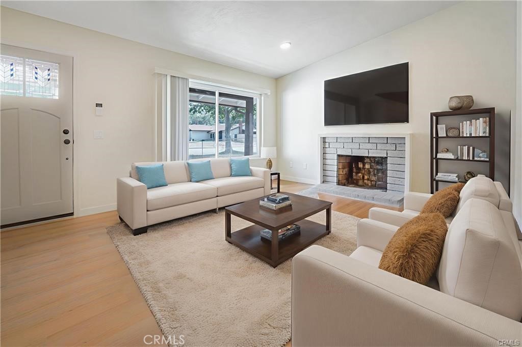 1594 Morgan Road San Bernardino, CA 92407 - Photo 25 of 31 a living room with furniture a fireplace and a flat screen tv
