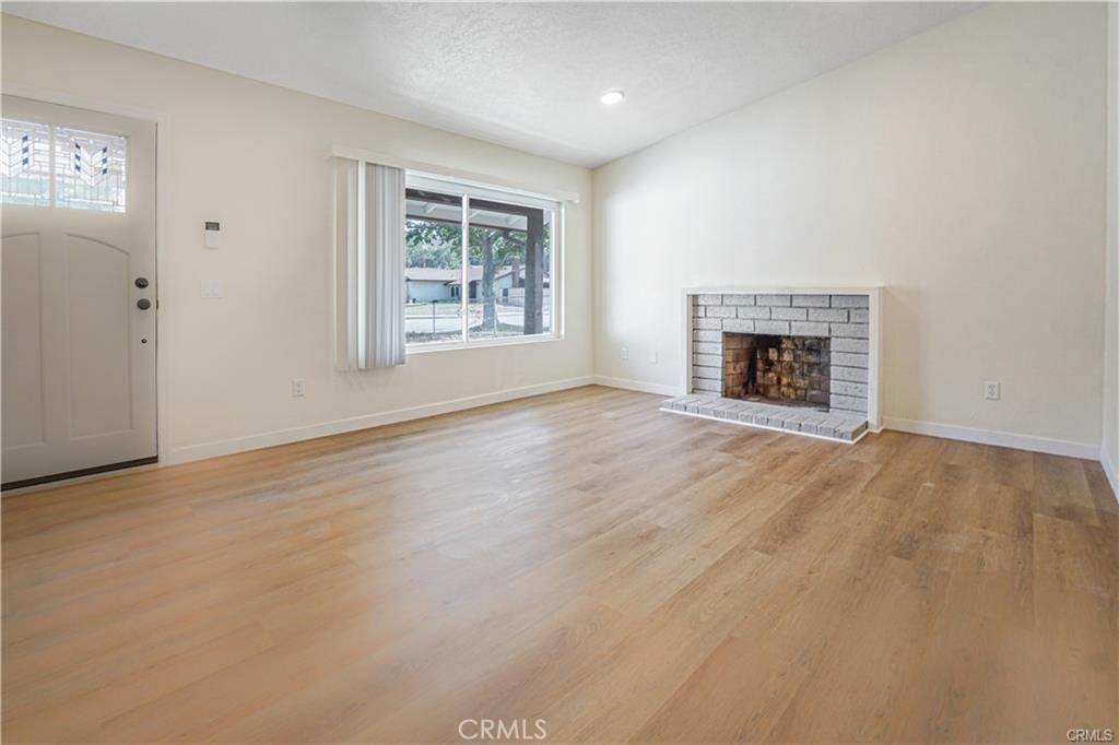 1594 Morgan Road San Bernardino, CA 92407 - Photo 26 of 31 an empty room with windows and fireplace