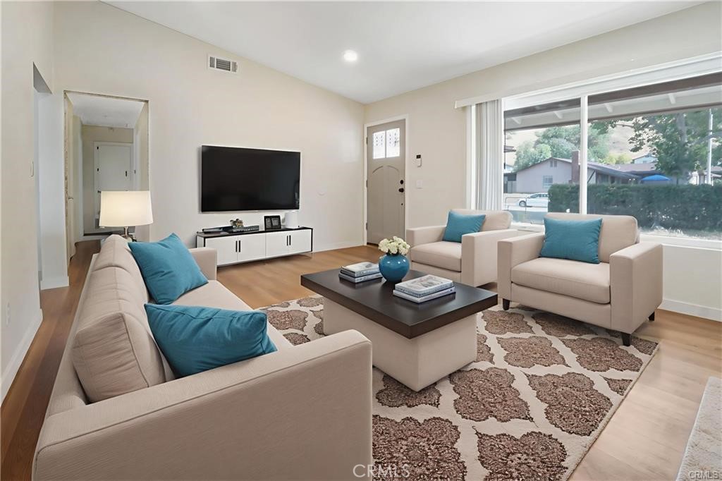 1594 Morgan Road San Bernardino, CA 92407 - Photo 3 of 31 a living room with furniture and a flat screen tv