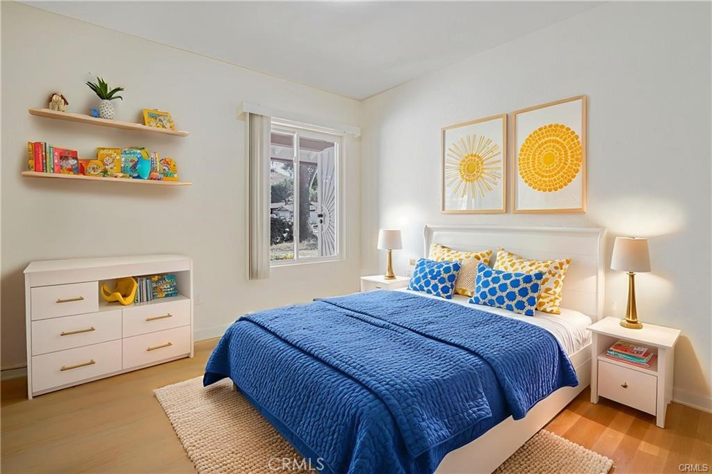 1594 Morgan Road San Bernardino, CA 92407 - Photo 4 of 31 a bedroom with a bed and a lamp on dresser