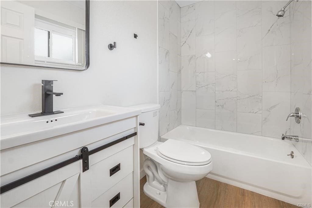 1594 Morgan Road San Bernardino, CA 92407 - Photo 8 of 31 a bathroom with a sink a toilet and shower