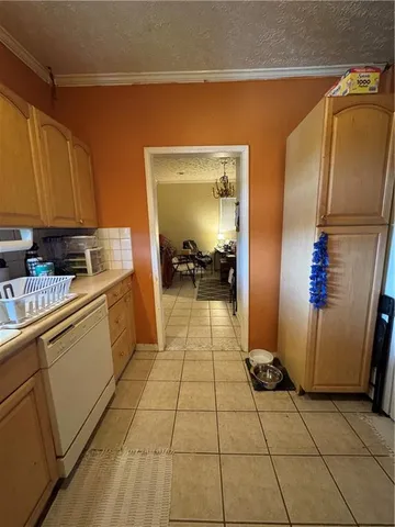 a kitchen with a sink a refrigerator and cabinets
