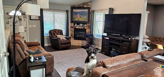 2269 Clear Creek Road Nibley, UT 84321 - Photo 6 of 27 Living room with healthy amount of natural light, vaulted ceiling, wood finished floors, and a stone fireplace
