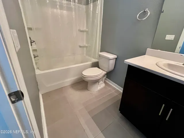 a bathroom with a toilet a sink and a shower
