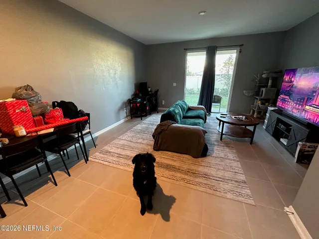 a view of an empty room with a sink and a window