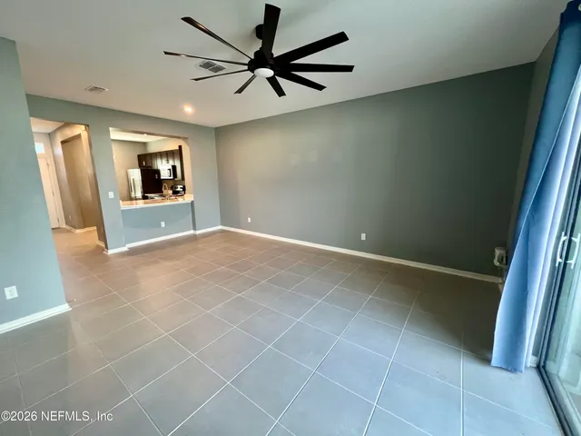 a kitchen with granite countertop a stove a sink and a refrigerator
