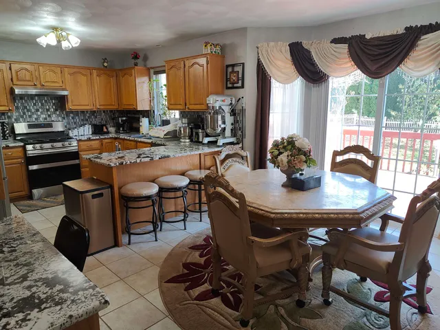 a view of a dining room with furniture and window