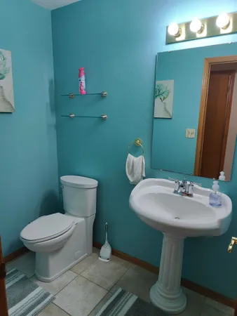 a bathroom with a sink toilet and a mirror