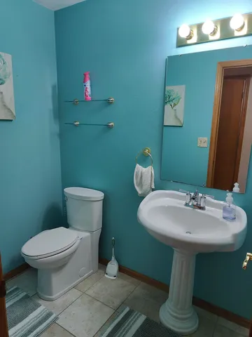 a bathroom with a sink toilet and a mirror