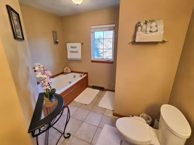 a bathroom with a sink mirror vanity and toilet