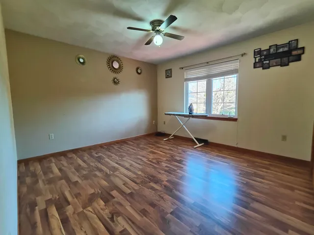 wooden floor in an empty room with a window