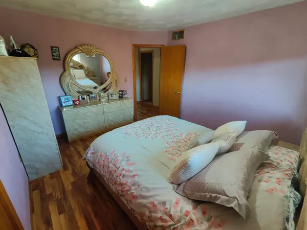 a bedroom with a bed and a mirror