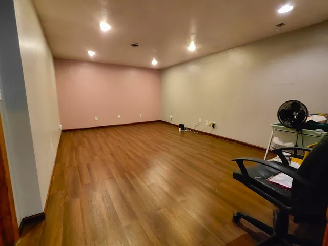 a view of a room with wooden floor