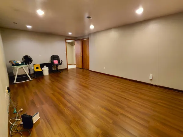 a view of a room with wooden floor and windows