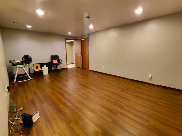 a view of a room with wooden floor and windows
