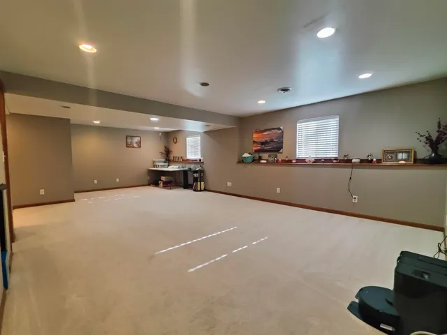 a very nice looking room with a large window and furniture