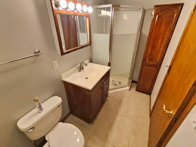 a bathroom with a sink a toilet a mirror and tub